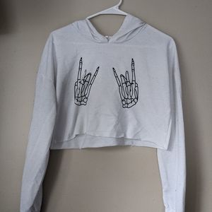 Small crop skeleton hands rock on shirt